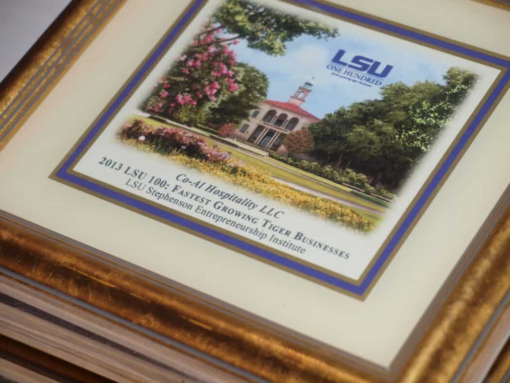 A framed certificate awarded to Co-Alt Hospitality LLC by LSU for being one of the 2013 fastest growing Tiger businesses.